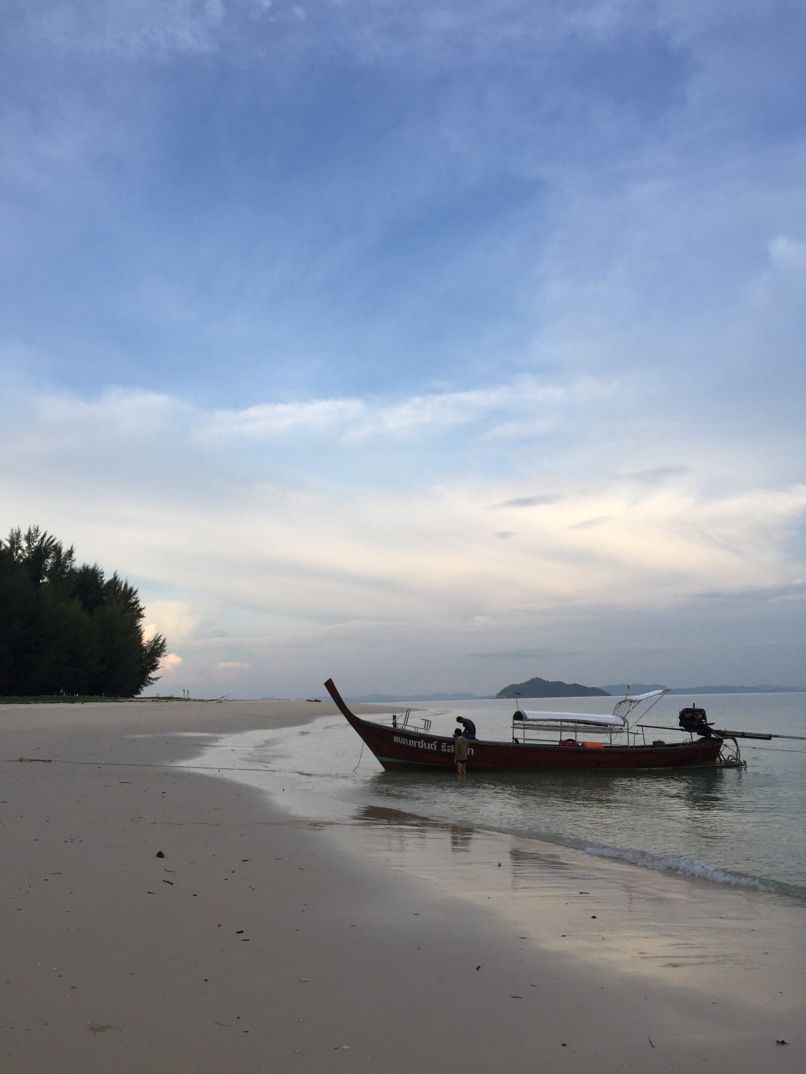 Peaceful beach and long-tail boat at Koh Bulon-Lae